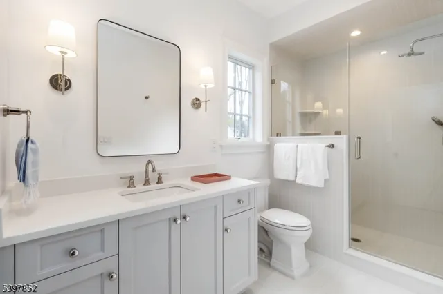 a spacious bedroom with a bed and a chandelier