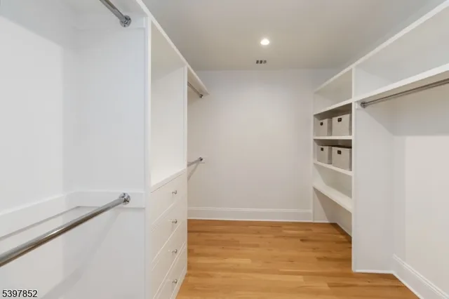 a bathroom with a sink vanity granite tub shower and a mirror