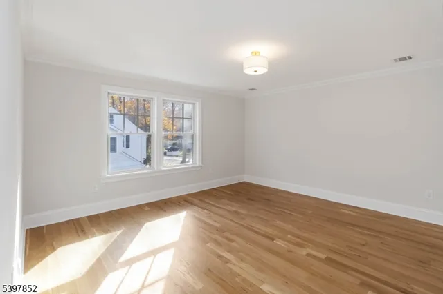 a bathroom with a toilet a sink a mirror and vanity