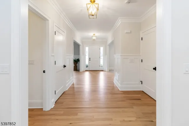 a view of a hallway with wooden floor