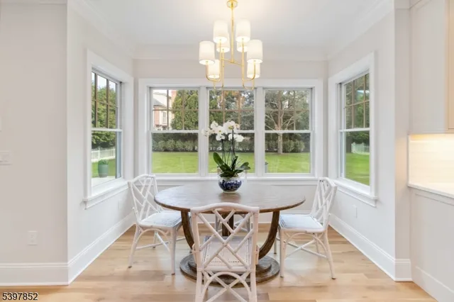 a view of a dining room with furniture wooden floor and chandelier
