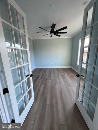 a large kitchen with kitchen island a stove a sink a center island and a chandelier