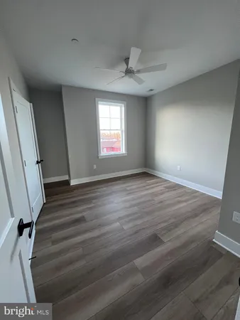 a room with a window and wooden floor