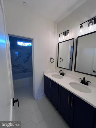 a living room with furniture kitchen and a chandelier