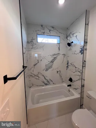 a view of a dining room with furniture a chandelier and wooden floor