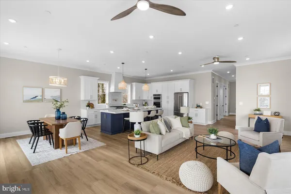 a kitchen with stainless steel appliances a stove a white cabinets and a window