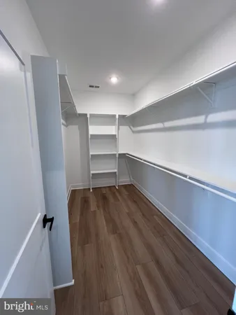a bathroom with a granite countertop toilet sink and mirror
