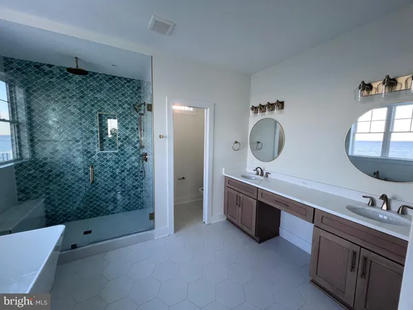 a view of a room with wooden floor and a ceiling fan