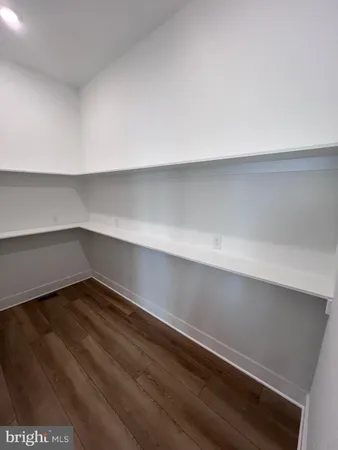 a kitchen with stainless steel appliances white cabinets and a window