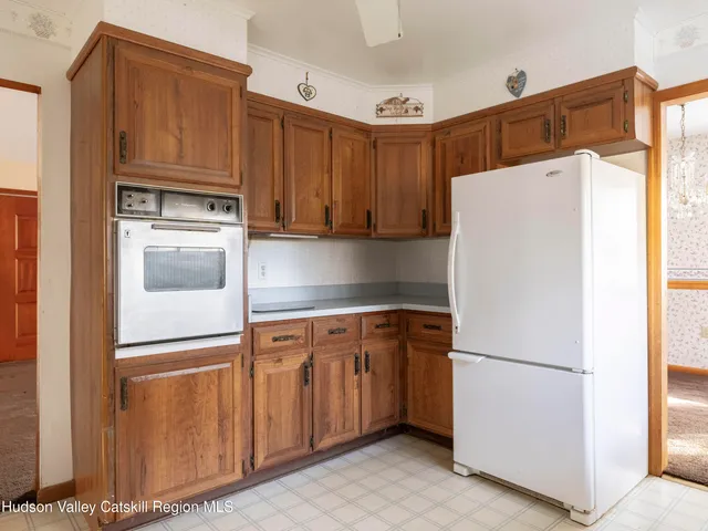 a white refrigerator freezer sitting in a kitchen