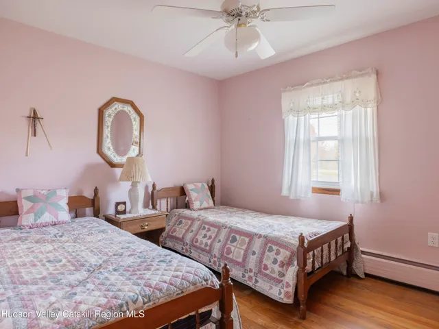 a bedroom with two beds and a chandelier