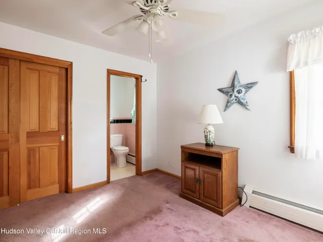 a view of a livingroom with furniture and chandelier fan