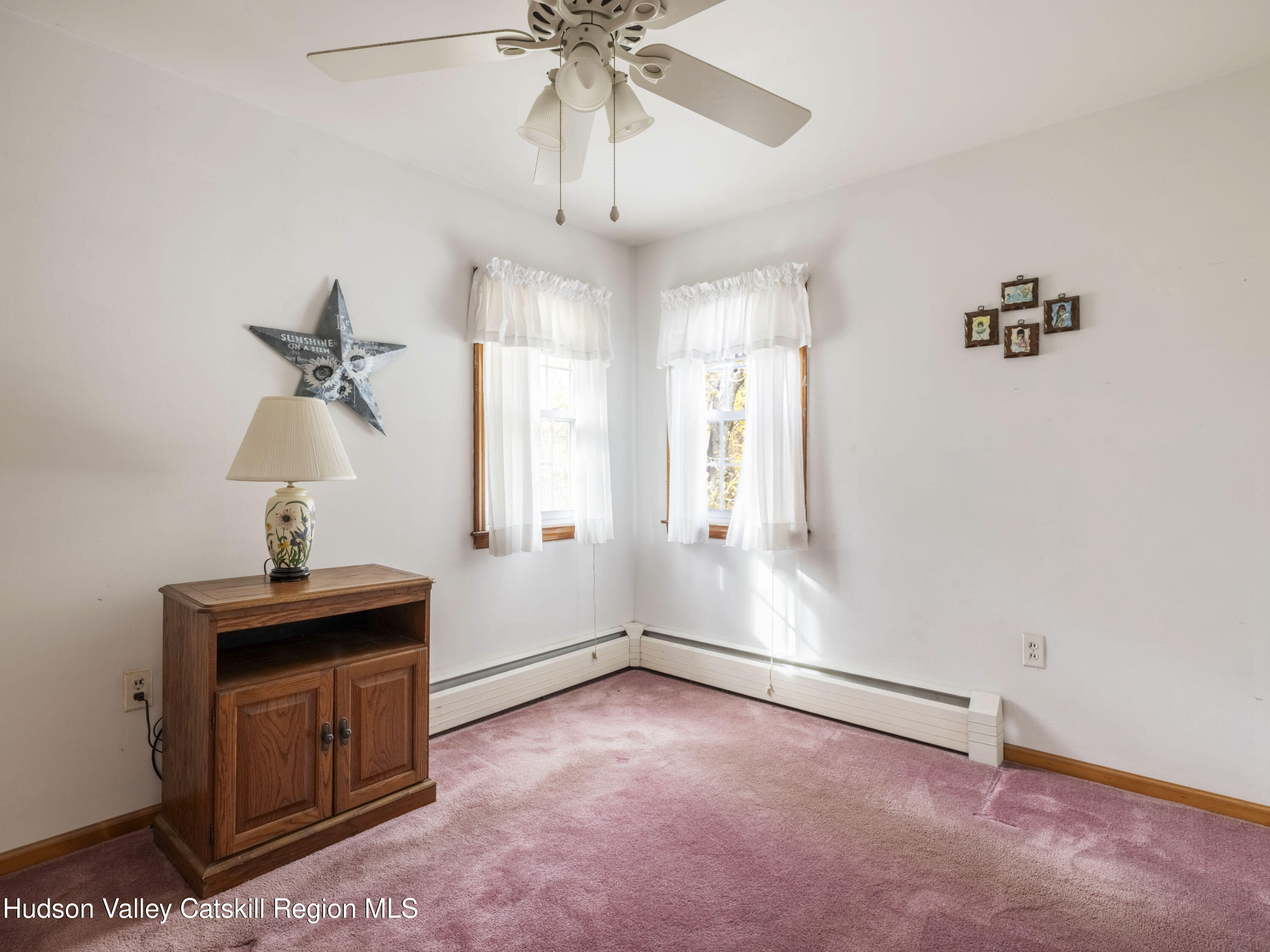 252 Highway 199 Red Hook, NY 12571 - Photo 19 of 45 a view of a room with a ceiling fan and a window