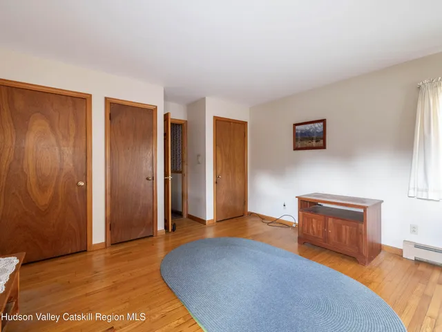 a bedroom with a bed and a view of room