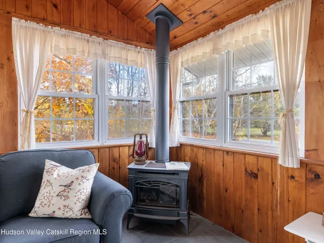 a living room with furniture and large windows