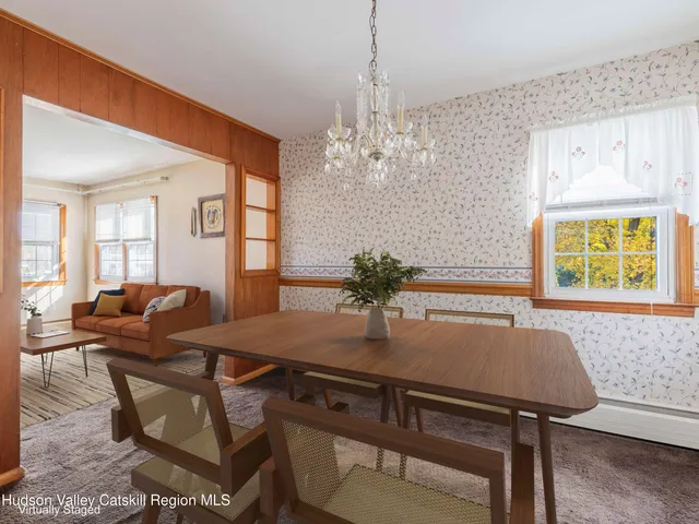 a view of a dining room with furniture and window
