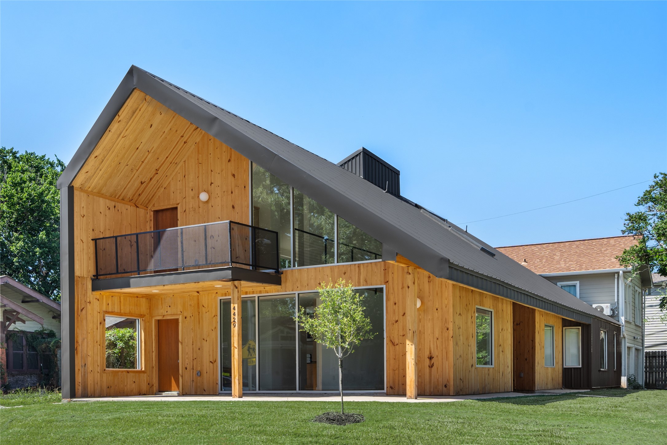 4429 Woodside Street, Unit B Houston, TX 77023 - Photo 1 of 17 a view of a big building with big yard and large trees