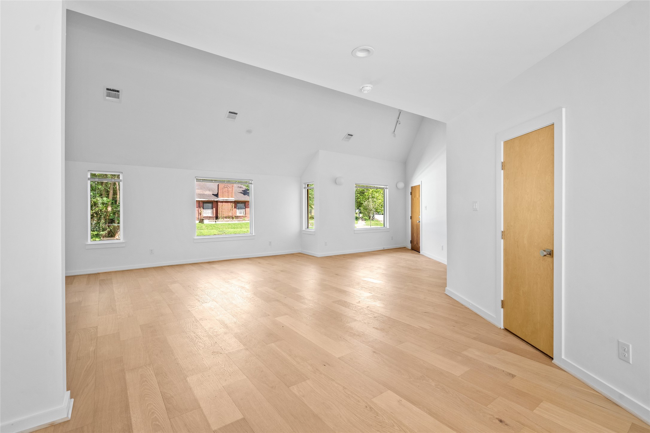 4429 Woodside Street, Unit B Houston, TX 77023 - Photo 12 of 17 a view of an empty room with window and wooden floor