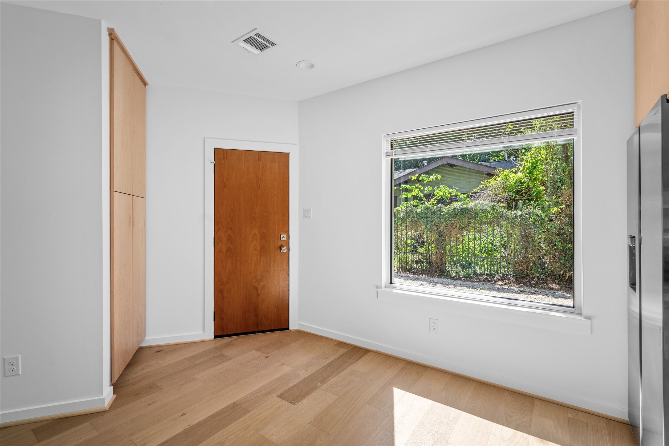 4429 Woodside Street, Unit B Houston, TX 77023 - Photo 13 of 17 a view of an empty room with wooden floor and a window