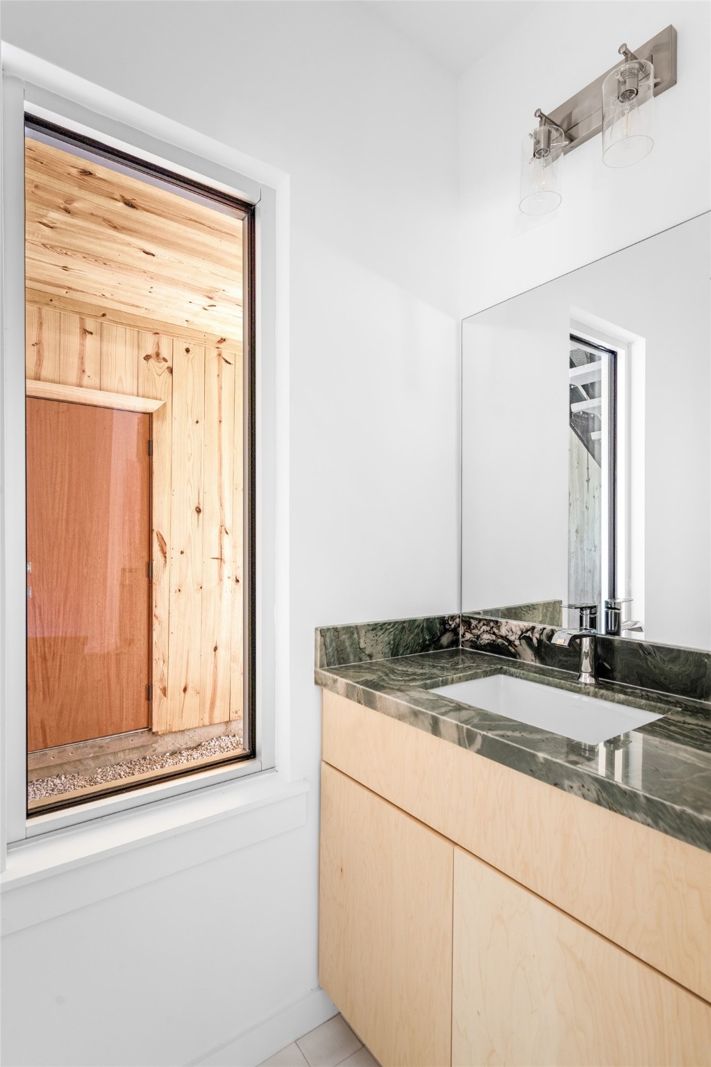 4429 Woodside Street, Unit B Houston, TX 77023 - Photo 14 of 17 a bathroom with a granite countertop sink and a mirror