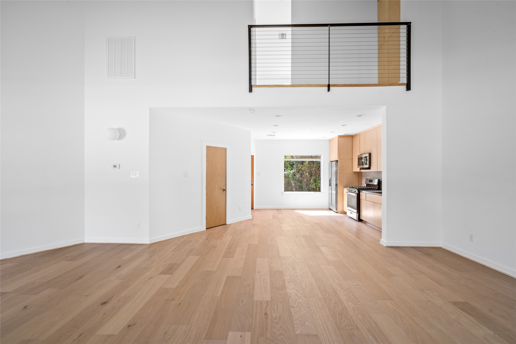 4429 Woodside Street, Unit B Houston, TX 77023 - Photo 7 of 17 a view of a room with wooden floor and a window