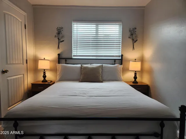 a bedroom with a bed and window