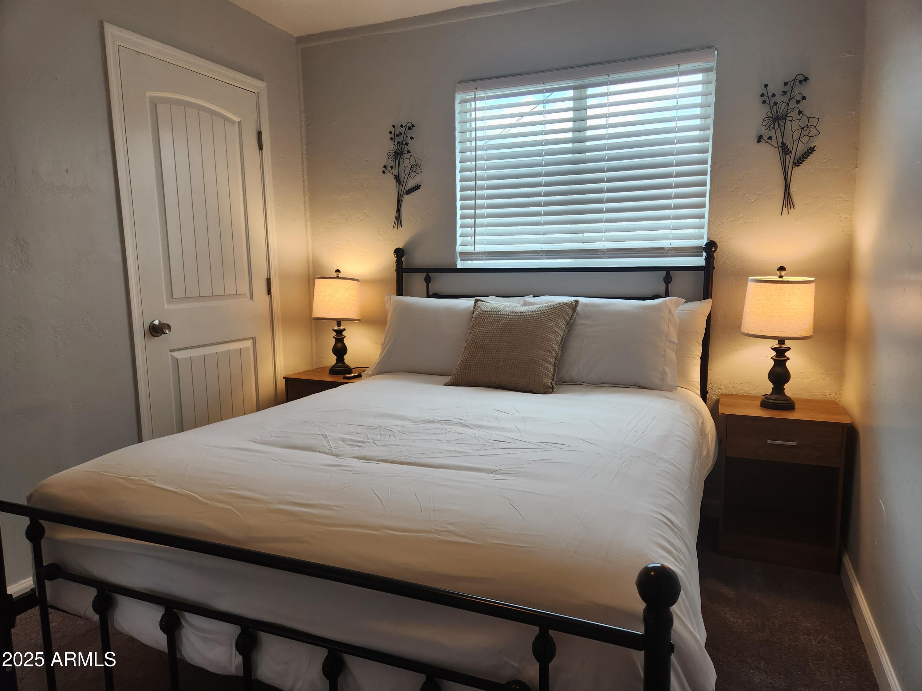 299 South Oregon Street, Unit 4 Chandler, AZ 85225 - Photo 12 of 39 a bedroom with a bed and a lamp