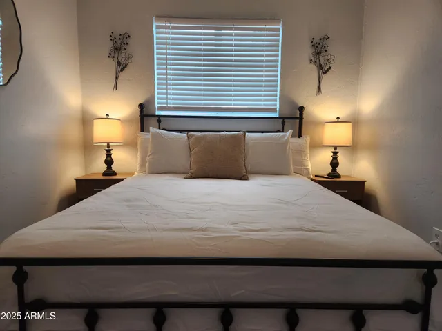 a bedroom with a bed and a lamp