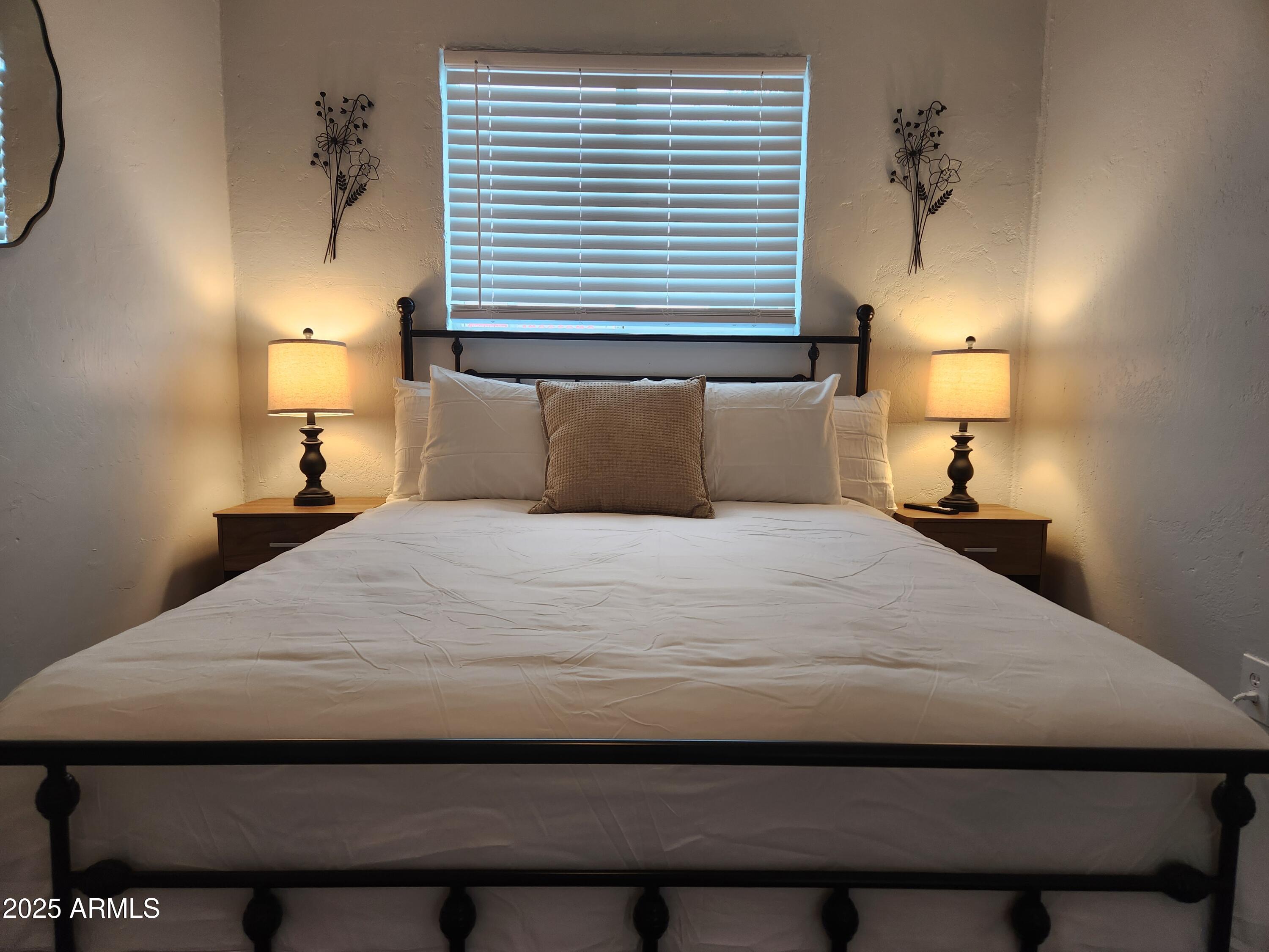 299 South Oregon Street, Unit 4 Chandler, AZ 85225 - Photo 13 of 39 a bedroom with a bed and a lamp