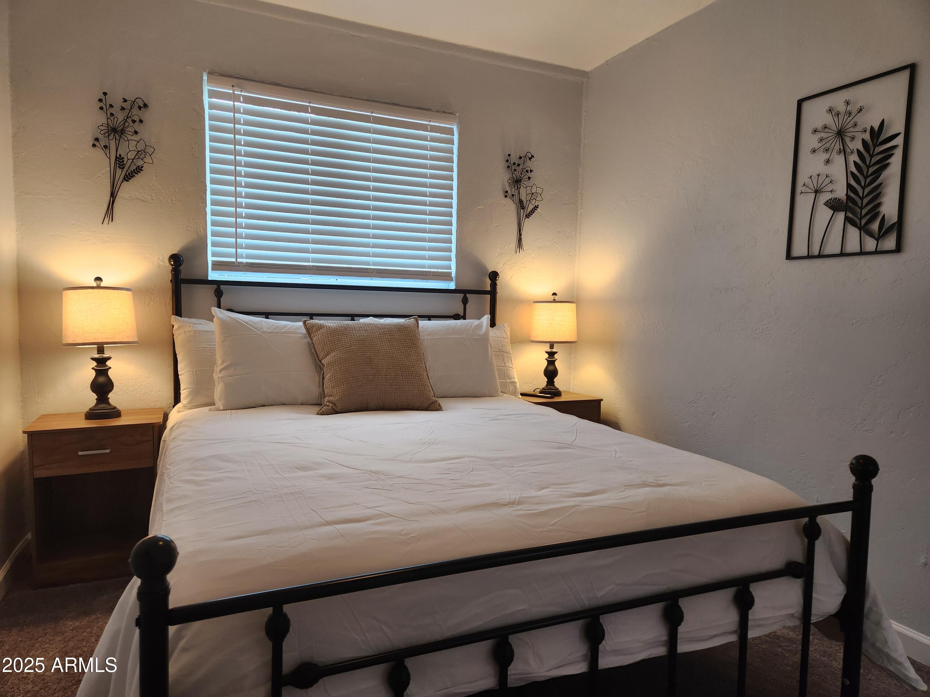 299 South Oregon Street, Unit 4 Chandler, AZ 85225 - Photo 14 of 39 a bedroom with a bed and a lamp on dresser