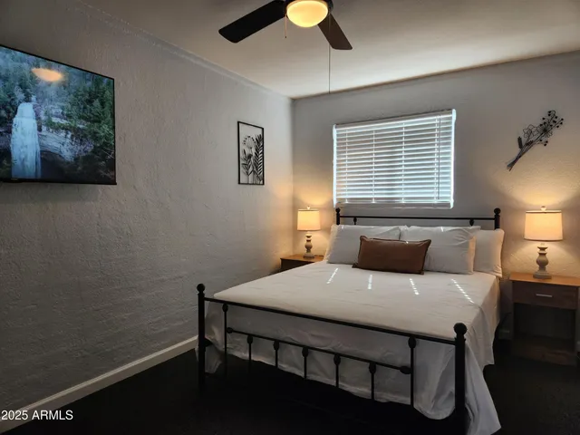 a bedroom with a bed and a window