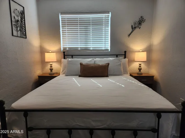 a bedroom with a bed and a lamp