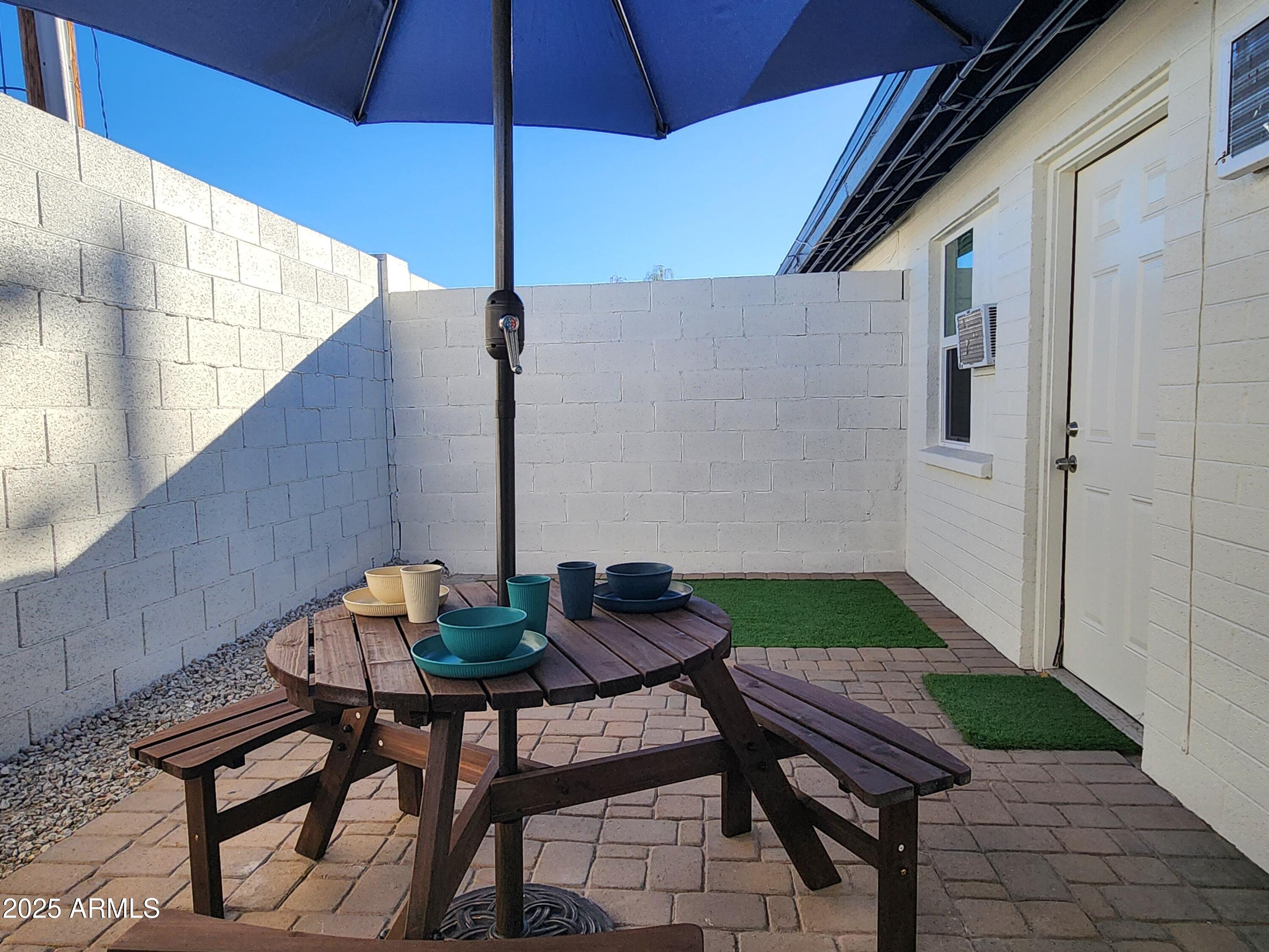 299 South Oregon Street, Unit 4 Chandler, AZ 85225 - Photo 2 of 39 a backyard of a house with table and chairs