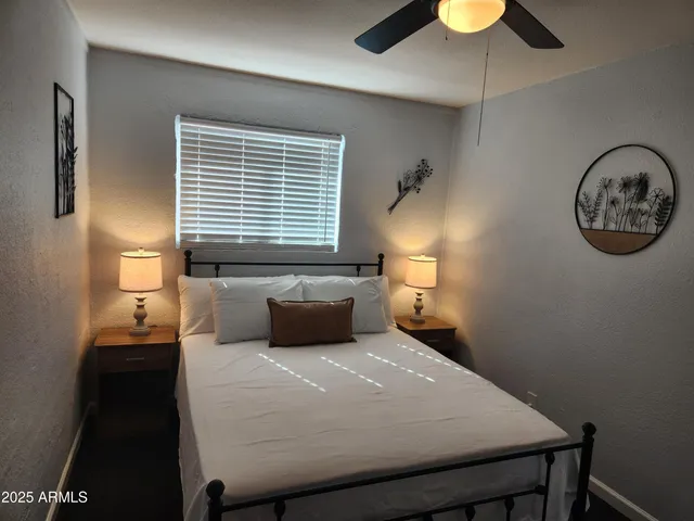 a bedroom with a bed and a chandelier