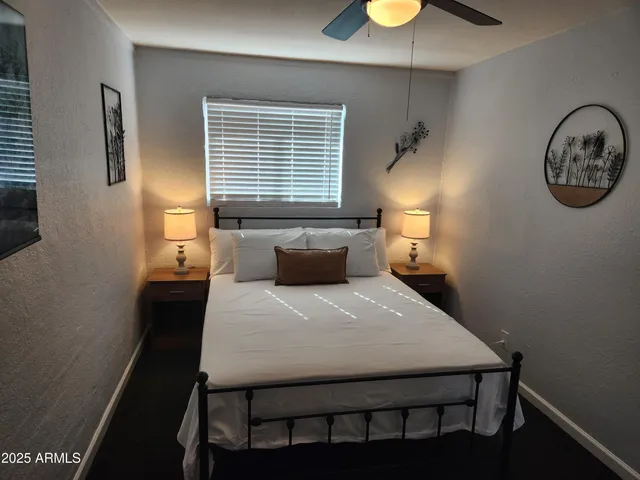 a bedroom with a bed and a lamp on the table