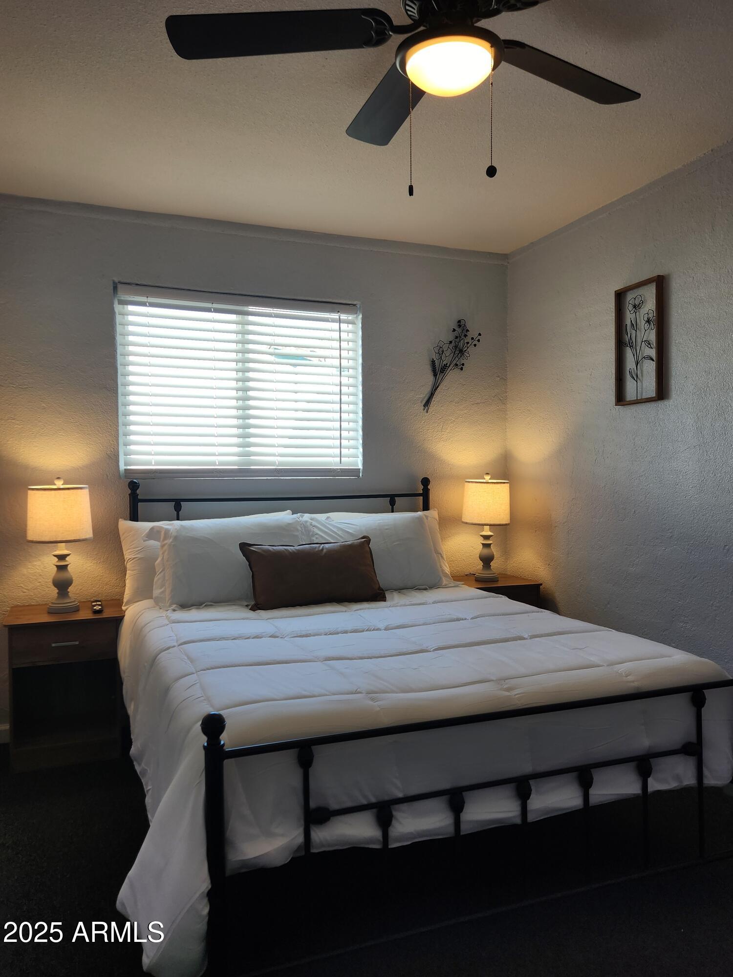 299 South Oregon Street, Unit 4 Chandler, AZ 85225 - Photo 23 of 39 a bedroom with a bed and a lamp