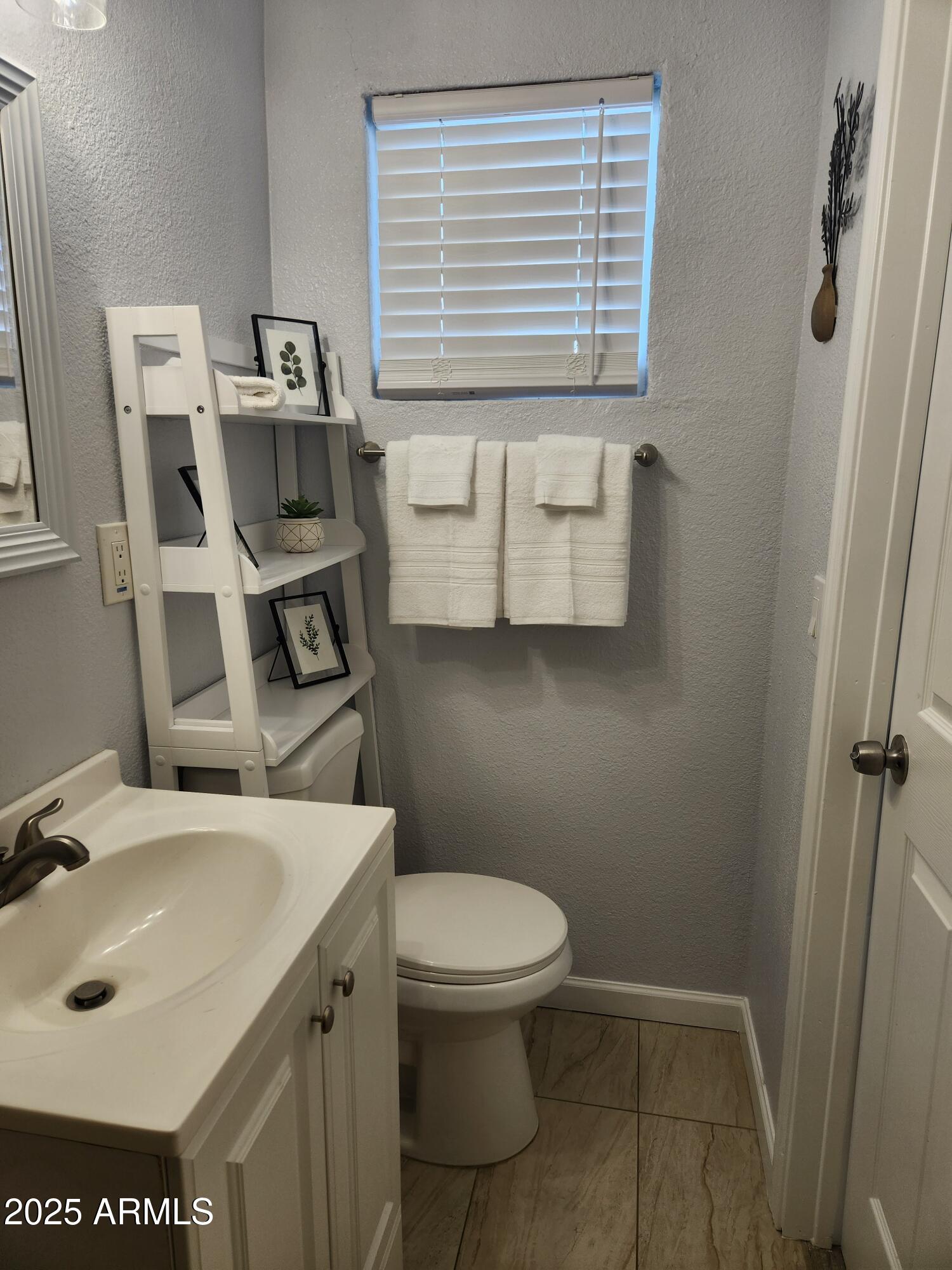 299 South Oregon Street, Unit 4 Chandler, AZ 85225 - Photo 28 of 39 a bathroom with a sink a toilet and a mirror