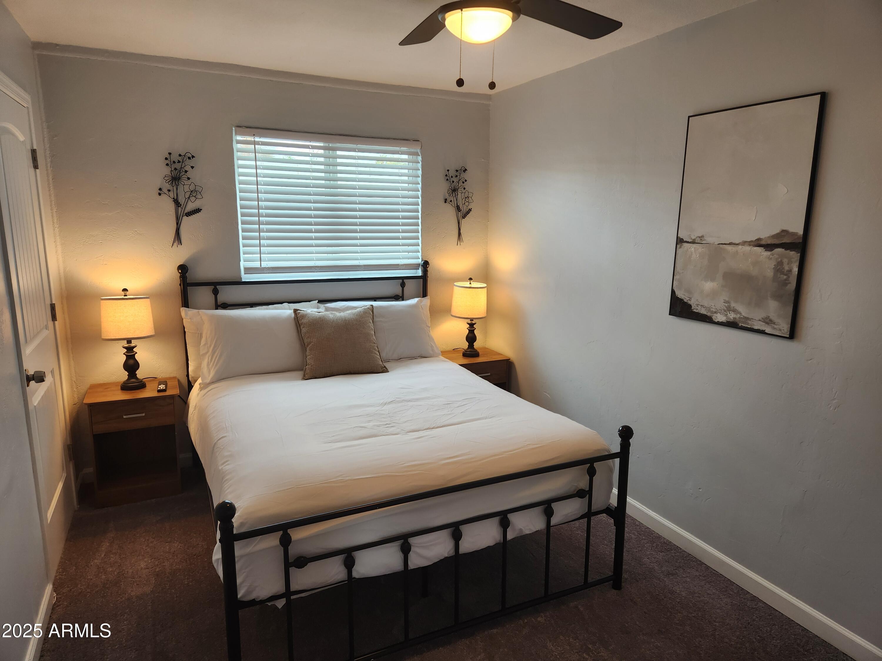 299 South Oregon Street, Unit 4 Chandler, AZ 85225 - Photo 34 of 39 a bedroom with a bed and a chandelier