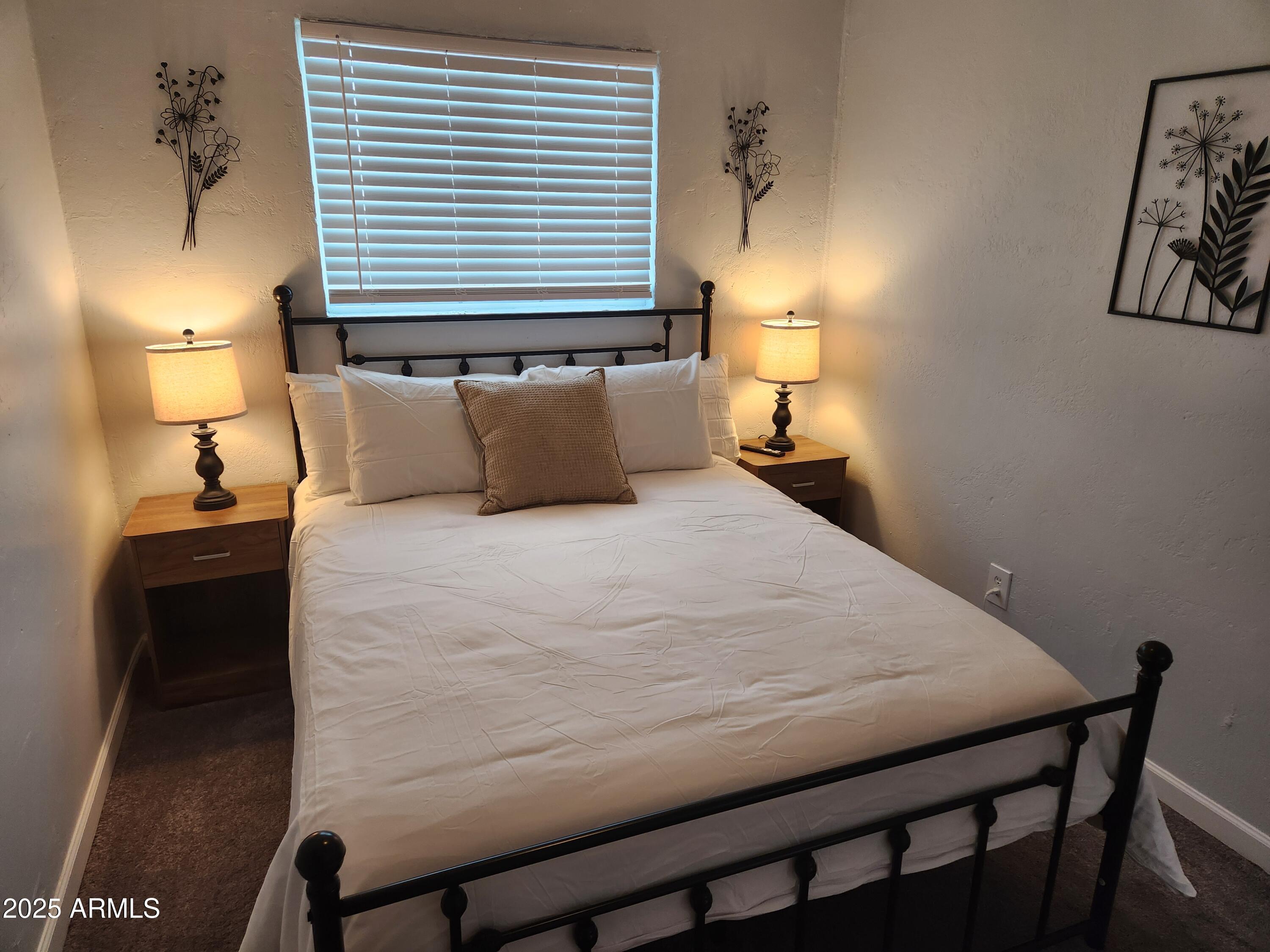 299 South Oregon Street, Unit 4 Chandler, AZ 85225 - Photo 35 of 39 a bed sitting in a bedroom next to a lamp