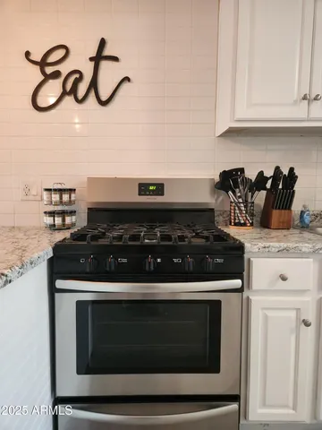 a stove top oven sitting inside of a kitchen