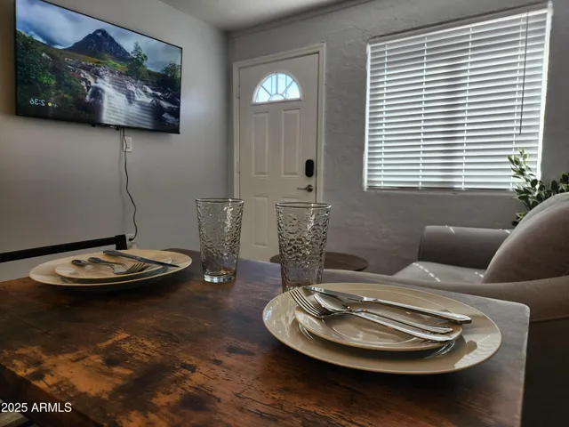 a dining room with furniture and window