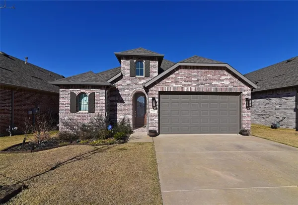 a front view of a house with yard and parking space