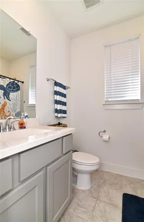 a bathroom with a sink toilet and vanity
