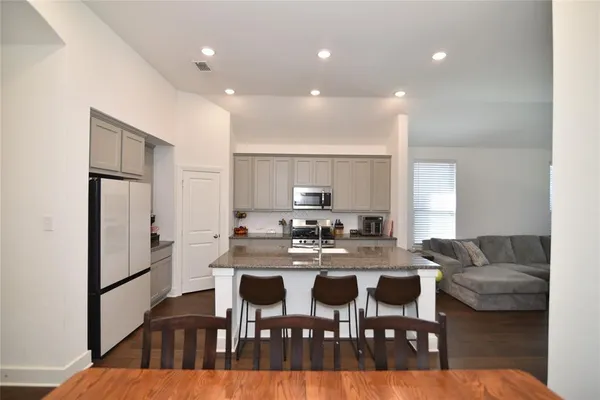 a view of a dining room with furniture and wooden floor