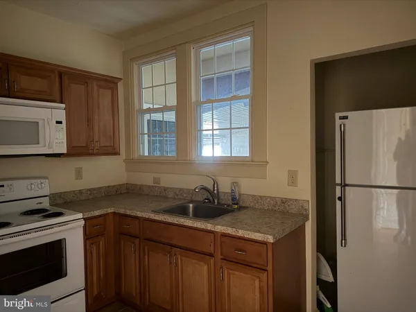 a kitchen with a sink stove and refrigerator