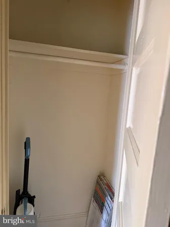 an empty room with wooden floor and closet