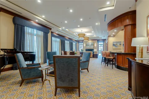 a dining room with furniture and a chandelier