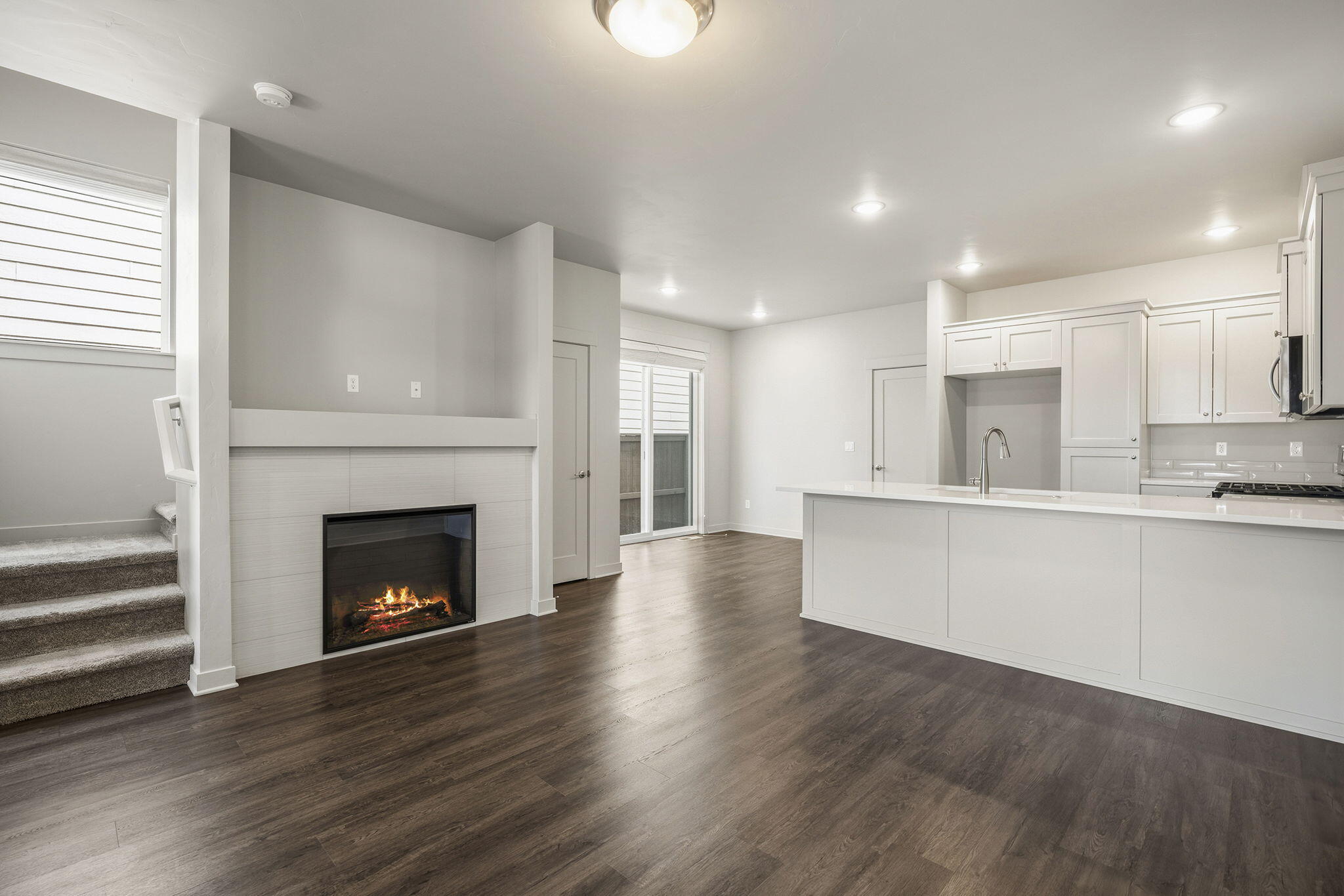 2366 Northeast Victor Place Bend, OR 97701 - Photo 5 of 31 a view of an empty room with wooden floor and a kitchen