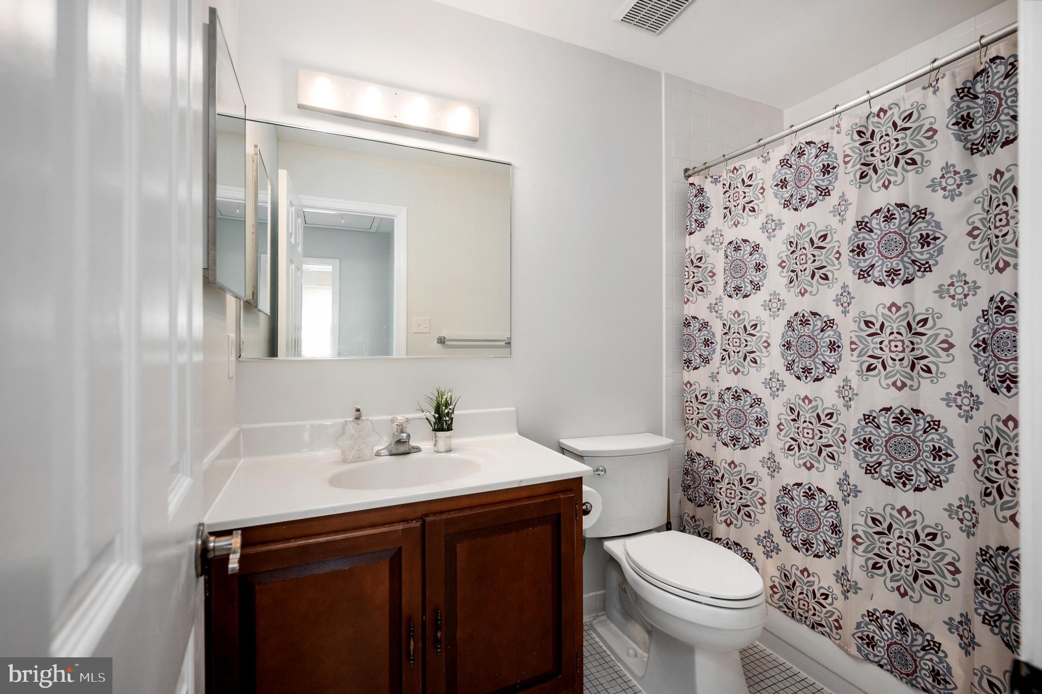 8202 Rushing Creek Drive Springfield, VA 22153 - Photo 28 of 44 Guest bathroom, tiled floors and tub walls