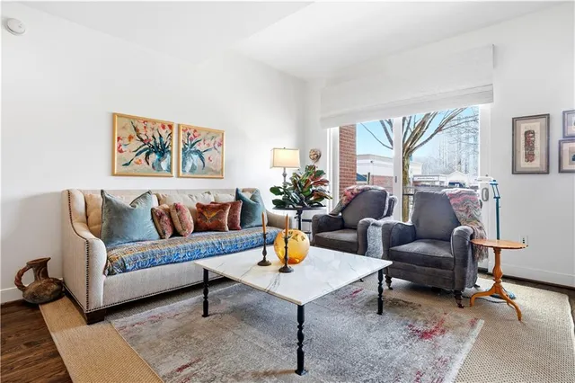 a living room with furniture and a potted plant
